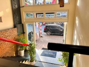 a view of a street with a car parked outside a store at Khách Sạn Nam Anh in Can Tho