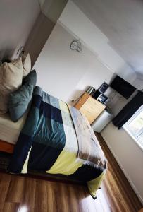 a small room with a bed and a room with a window at Double guest room in Sedgley
