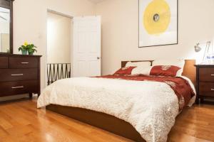 a bedroom with a bed and a dresser at Spacious Passyunk Square 3BR House in Philadelphia