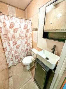 a small bathroom with a toilet and a sink at COMPLIMENTARY CAR! Casa Del Mar! in Nassau