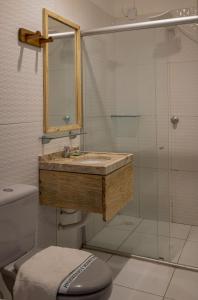 a bathroom with a sink and a shower at Pousada Chez Ellery Jeri in Jericoacoara