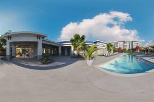 a resort with a swimming pool in front of a building at LuxAprt NearAirport&StJohnsRiver in Jacksonville