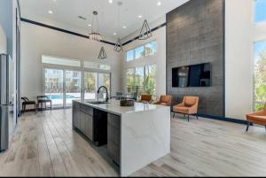 a kitchen and living room with a fireplace and a tv at LuxAprt NearAirport&StJohnsRiver in Jacksonville