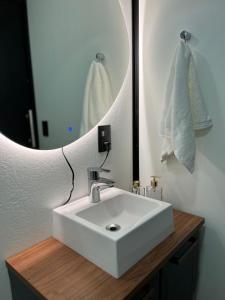 bagno con lavandino bianco e specchio di Bosque Shalom a Frederico Westphalen