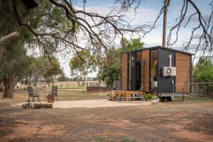a tiny house with a picnic table and chairs at Banyena Homestead 