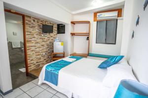 Postel nebo postele na pokoji v ubytování Maidith Galapagos Inn