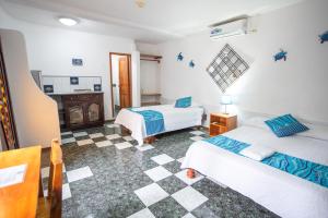 Postel nebo postele na pokoji v ubytování Maidith Galapagos Inn