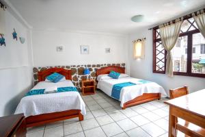 Postel nebo postele na pokoji v ubytování Maidith Galapagos Inn