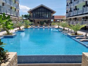 a swimming pool in the middle of a building at Stay and Fly at Amani Grand Resort Residences in Mactan