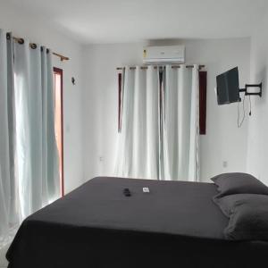 Un pat sau paturi într-o cameră la Recanto Boulevard
