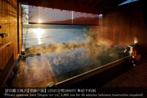 a bath tub with steam coming out of it at Aki Grand Hotel & Spa in Miyajima