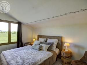 een slaapkamer met een groot bed en een raam bij Gîte Saint-Forgeux-Lespinasse, 6 pièces, 12 personnes - FR-1-496-7 in Saint-Forgeux-Lespinasse