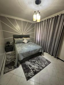 a bedroom with a bed and some curtains at Tranquility In the Center of Fez in Fez