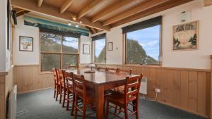 a dining room with a wooden table and chairs at Powderkeg in Dinner Plain