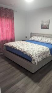 a bedroom with a bed with a blue mattress at Comfy one bedroom Airdrie in Airdrie