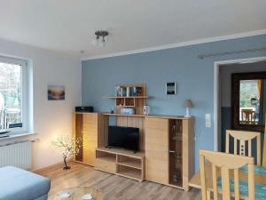 a living room with a entertainment center with a flat screen tv at Ferienwohnung-Min-Droom in Sankt Peter-Ording