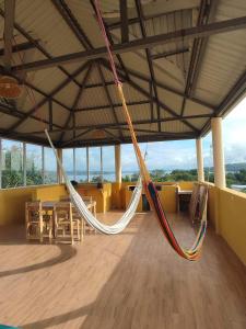 a hammock in a room with a table and chairs at La Casa Colorada in San Benito