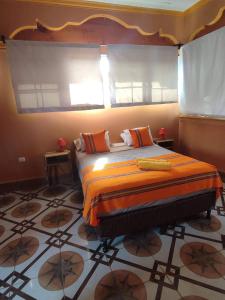 En eller flere senger på et rom på La Casa Colorada