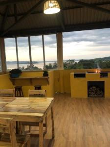 a room with tables and a fireplace in a building at La Casa Colorada in San Benito +26 photos