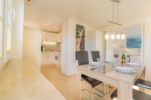 a dining room and kitchen with a table and chairs at Wohnung-A-303 in Böhl