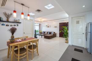a kitchen and living room with a table and chairs at Alex House Saigon - Serviced Apartment in Ho Chi Minh City