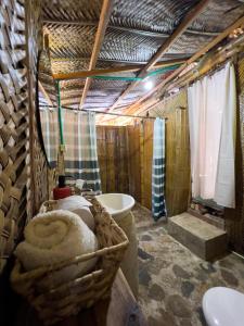 a bathroom with a sink and a bath tub at Los Achiotes Hostal in Palomino