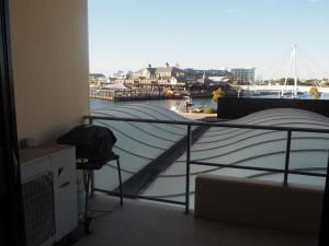 a bedroom with a bed and a view of a marina at Lovely 2 Bedroom Serviced Apartment & Free Parking in Mandurah