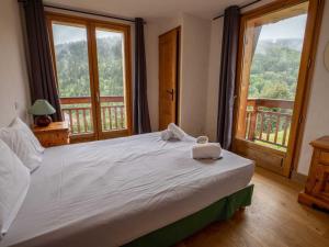 a bedroom with a large bed with two towels on it at Chalet Méribel, 11 pièces, 20 personnes - FR-1-688-81 in Les Allues