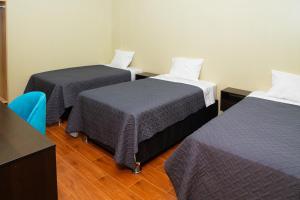 A bed or beds in a room at ENJLU INN Selva Central