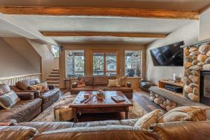 a living room with a couch and a table at Beautiful Mountain Modern Home 4Bedroom Spa in Whitefish