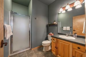a bathroom with a shower and a toilet and a sink at Beautiful Mountain Modern Home 4Bedroom Spa in Whitefish