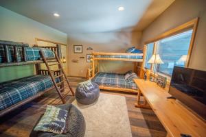 a living room with bunk beds and a tv at Beautiful Mountain Modern Home 4Bedroom Spa in Whitefish