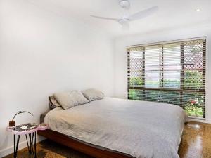 a bedroom with a large bed and a window at Benowa 1 Bedroom renovated townhouse in Gold Coast
