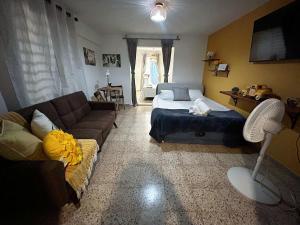 a living room with a bed and a couch at Casa Dona Guilla 1 in Luyando