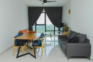a living room with a table and a couch at Southkey 2BR, 5-6 PAX, WIFI, Mid Valley JB, in Johor Bahru