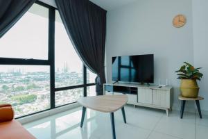 a living room with a table and a large window at Southkey 2BR, 5-6 PAX, WIFI, Mid Valley JB, in Johor Bahru