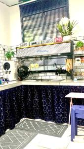 a kitchen with blue and white tiles on the counter at Nadialisa cottage homestay For Islamic only in Sungai Petani