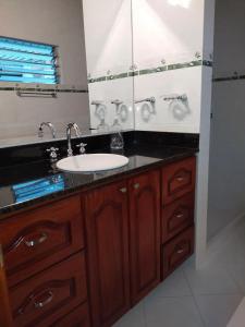 a bathroom with a sink and a mirror at Casa Nogal 76 in Medellín