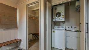 a small kitchen with a washer and dryer at 1-8 Hot Plate in Mount Hotham +10 photos