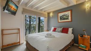 a bedroom with a large bed and a window at 1-8 Hot Plate in Mount Hotham