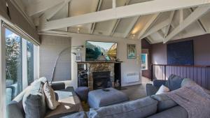 a living room with a couch and a fireplace at 1-8 Hot Plate in Mount Hotham