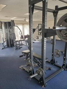 a gym with several tread machines in a room at Home Away From Home in Vero Beach