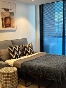 - une chambre avec un lit, un canapé et une fenêtre dans l'établissement The Southbank Central Retreat, à Melbourne