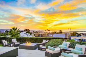 a patio with a fire pit and a sunset at Panoramic Ocean sunset Views with Heated Pool & Spa best location in San Diego