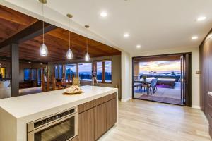 a kitchen with a view of a dining room at Panoramic Ocean sunset Views with Heated Pool & Spa best location in San Diego