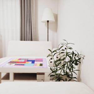 a living room with a table and a plant at 1978 stay in Seoul