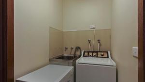 a small kitchen with a stove and a sink at 1750 Hotham 12 in Mount Hotham