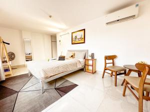 a bedroom with a bed and a table and chairs at Hồng Châu Hotel in Danang