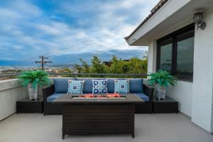 a patio with a couch and a fire pit on a balcony at Spacious Beautiful Home with Stunning Bay Views in San Diego