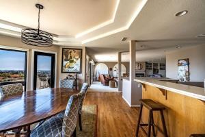 a kitchen and dining room with a large wooden table at Spacious Beautiful Home with Stunning Bay Views in San Diego